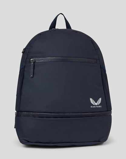 Navy backpack with front zip pocket and Castore logo on the lower right