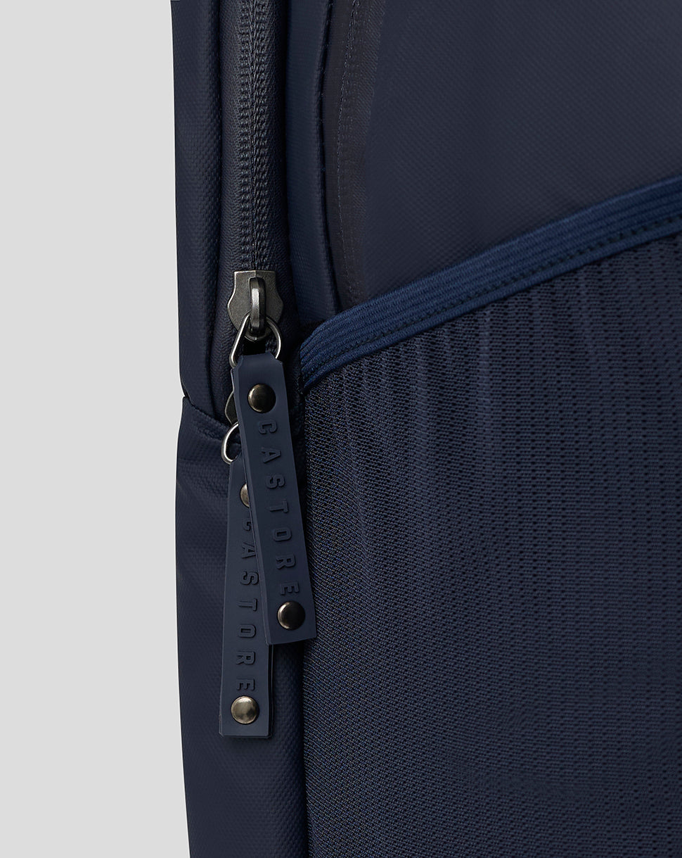 Close-up of navy backpack zipper with Castore branded pull and mesh side pocket