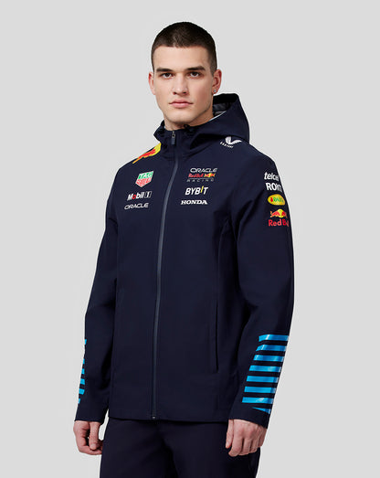 Model wearing navy water resistant jacket with Oracle Red Bull Racing logos and zipped front
