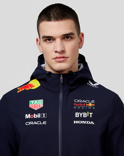Model wearing navy unisex Oracle Red Bull Racing water resistant jacket with sponsor logos on the chest.