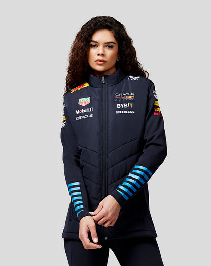 Front view of a woman wearing navy night sky Oracle Red Bull Racing teamline gilet with zipped front and sponsor logos on the chest and sleeves.