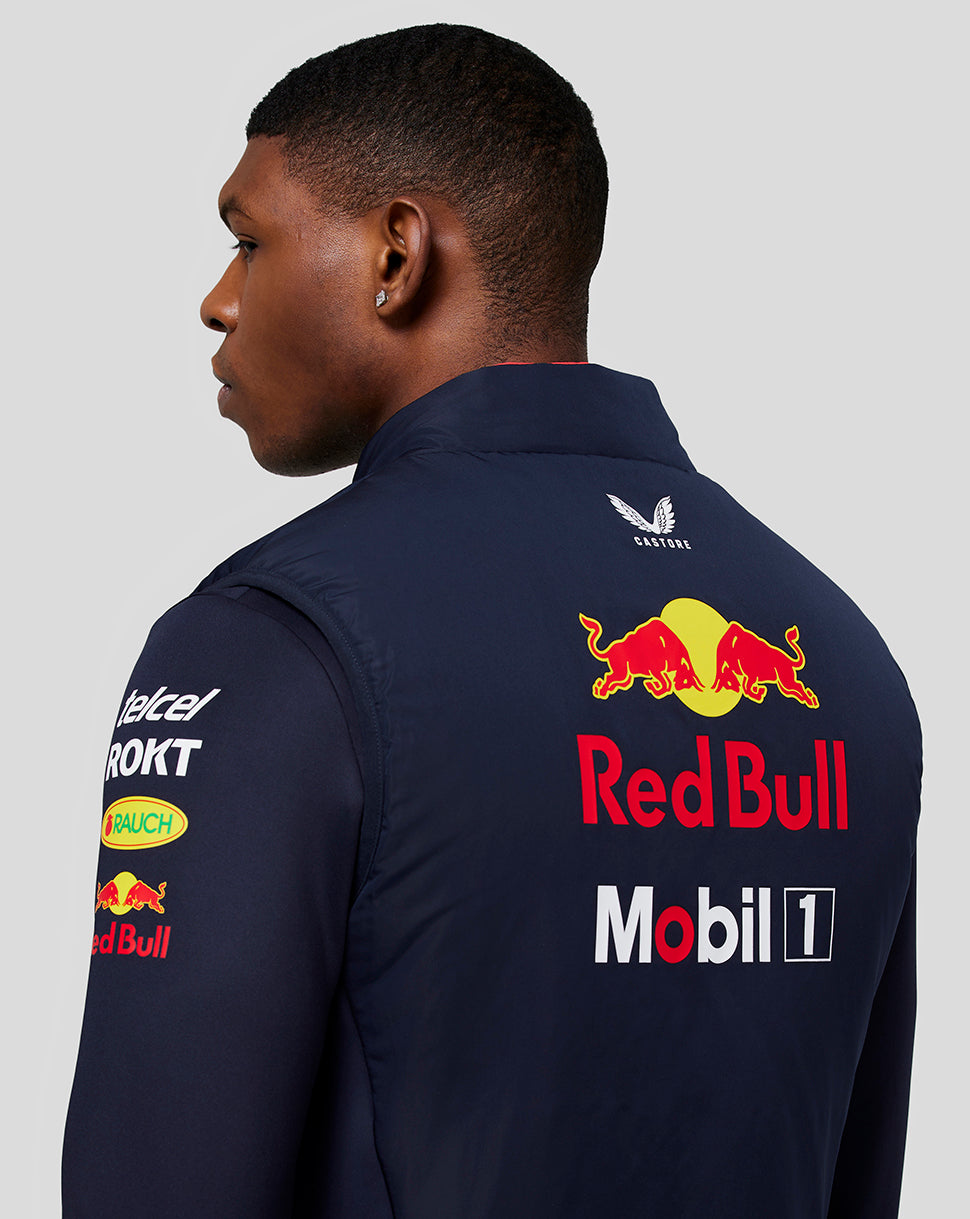 Back view of a person wearing navy night sky Oracle Red Bull Racing teamline gilet, with a large Red Bull logo on the back.