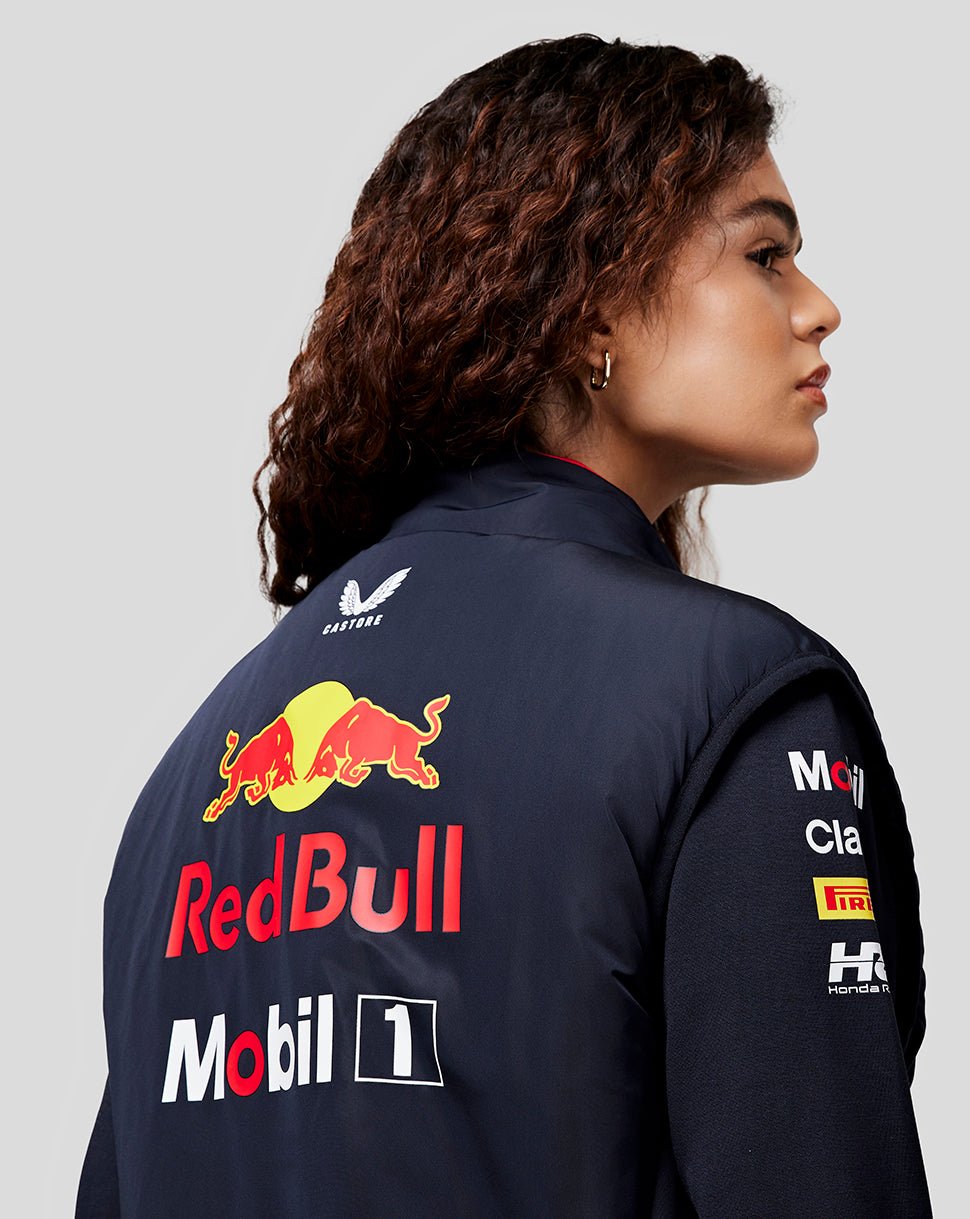 Back view of a model wearing the navy Night Sky Oracle Red Bull Racing Hybrid Gilet with bold Red Bull and Mobil 1 branding.