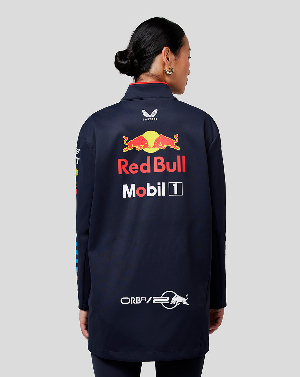 Rear view of a navy Red Bull Racing jacket on a female model with Castore branding at the neck and a large Red Bull logo on the back