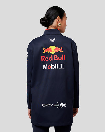 Rear view of a navy Red Bull Racing jacket on a female model with Castore branding at the neck and a large Red Bull logo on the back