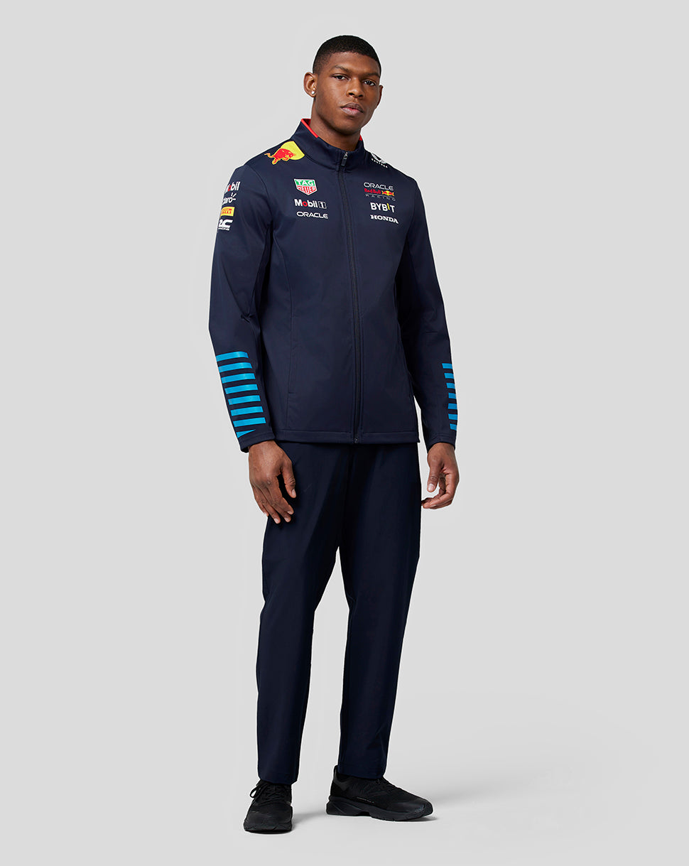 Male model in navy Oracle Red Bull Racing Teamline Soft Shell Jacket Night Sky shown full length standing