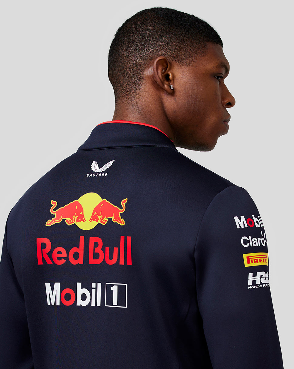 Back view close up of a navy team midlayer showing Red Bull branding on the back and sleeve logos including Mobil 1 and Pirelli