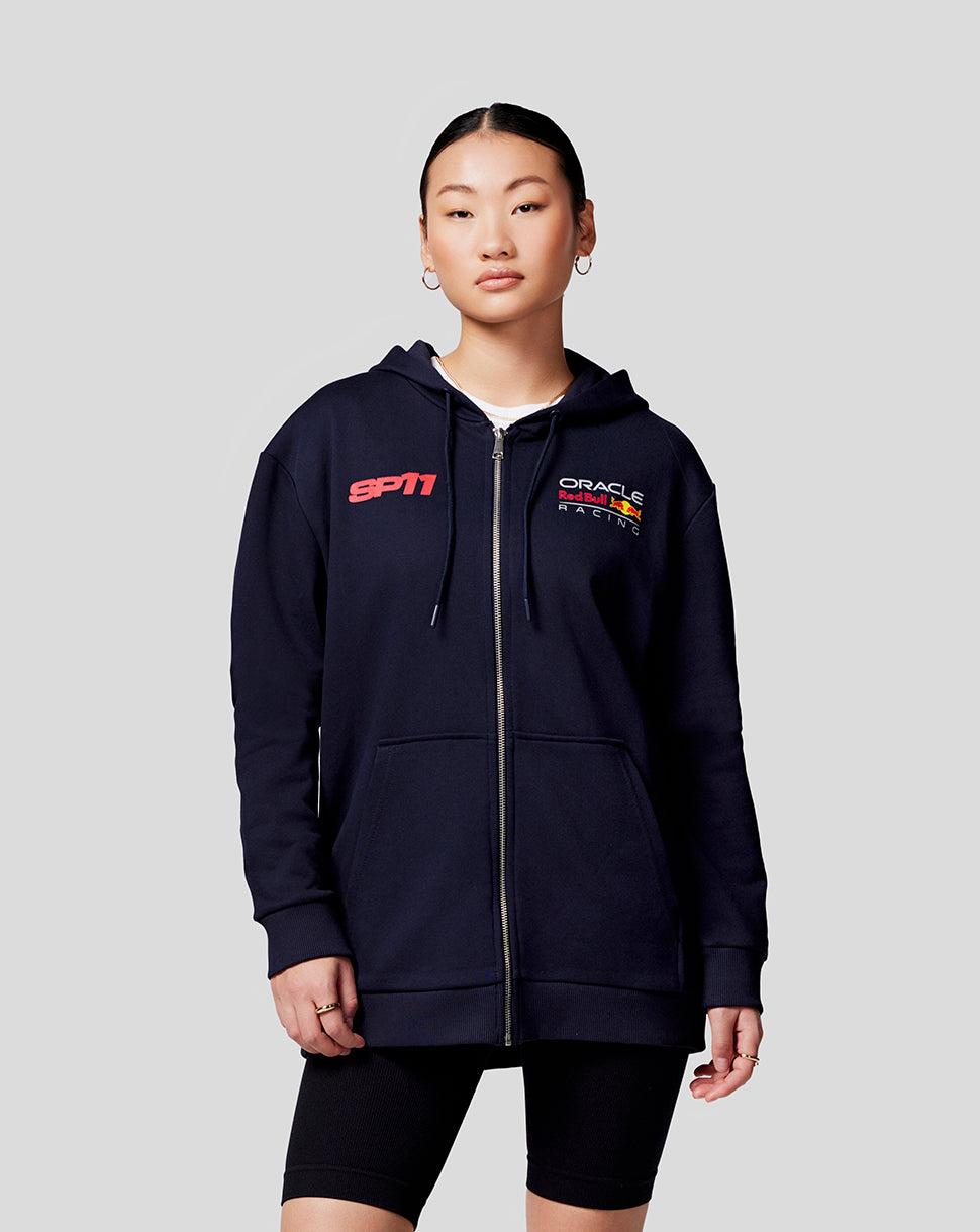 Back view of a woman in a navy Checo Race Car zip hoodie with a large distressed SP11 graphic and race car image on the back