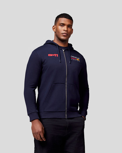 Front view of a model in the navy Checo Race Car Zip Hoodie featuring the SP11 graphic on the chest and Oracle Red Bull Racing branding