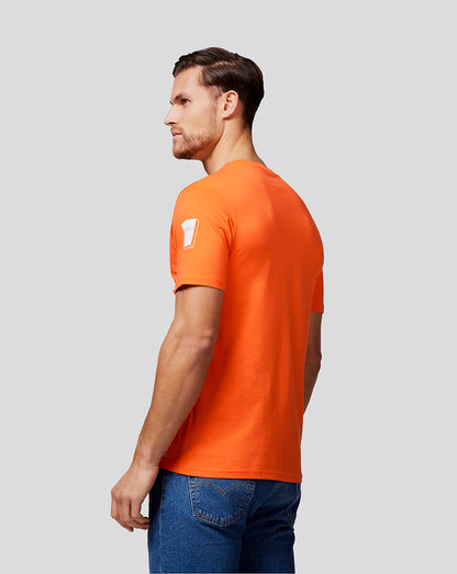 Side profile of a man in a bright orange Max Expression Tee with short sleeves.