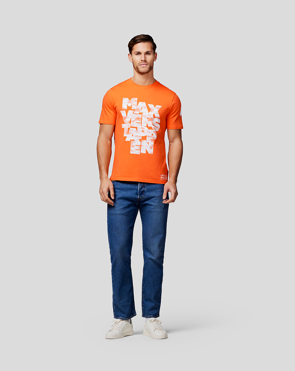 Full-body shot of male model in exotic orange Max Expression Tee with blue jeans and white sneakers