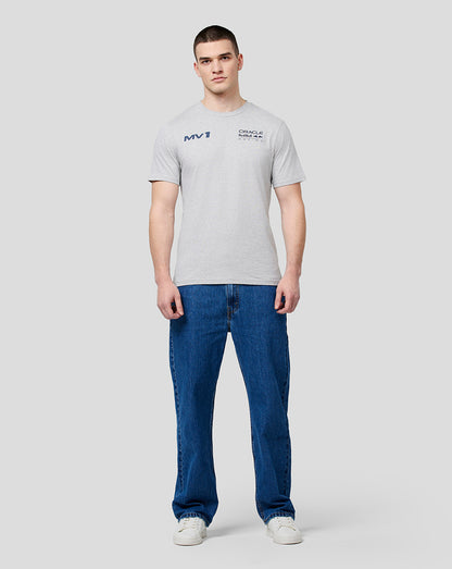 Full body shot of a male model in grey marl Max Helmet Tee with chest logos and blue jeans.