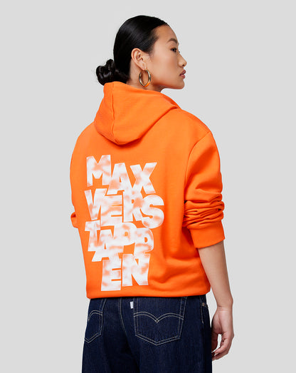 Profile view of a woman wearing an Exotic Orange Oracle Red Bull Racing Unisex Max Expression Hoodie with back graphic visible