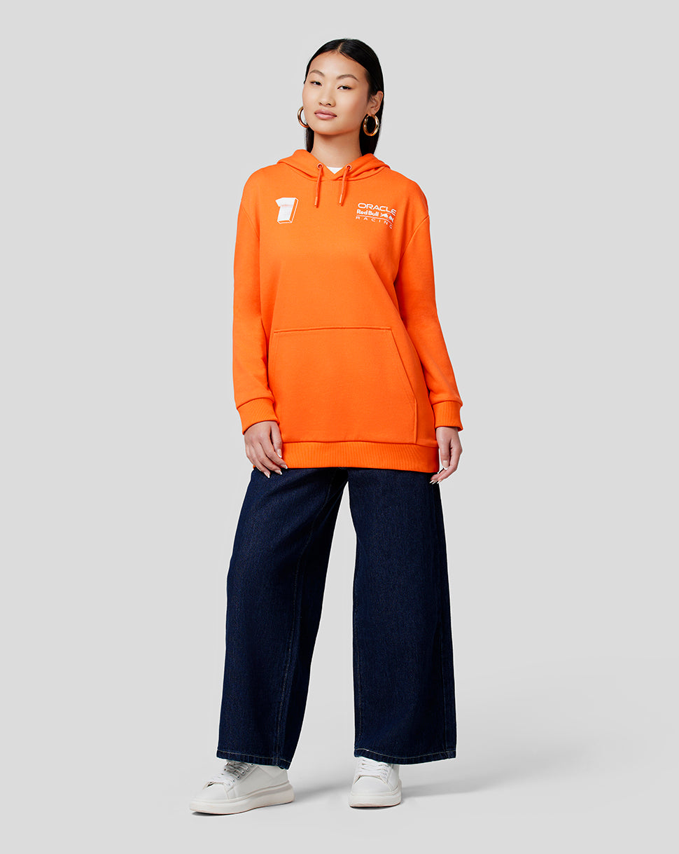 Model wearing exotic orange Max Expression hoodie with a front kangaroo pocket and chest logo.