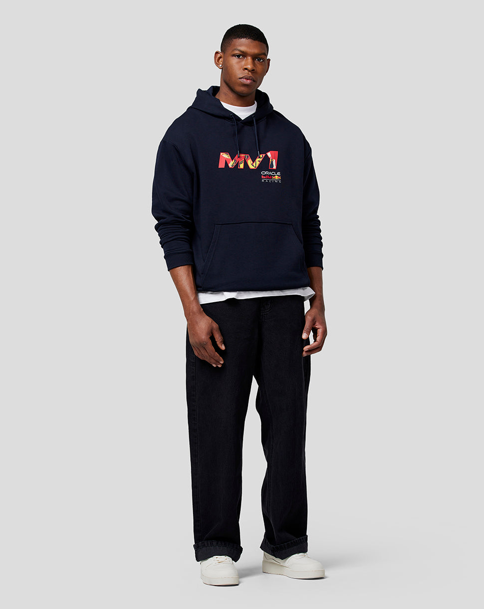 Full-body shot of male model in navy oversized hoodie with front graphic, white tee peeking out, and black jeans.