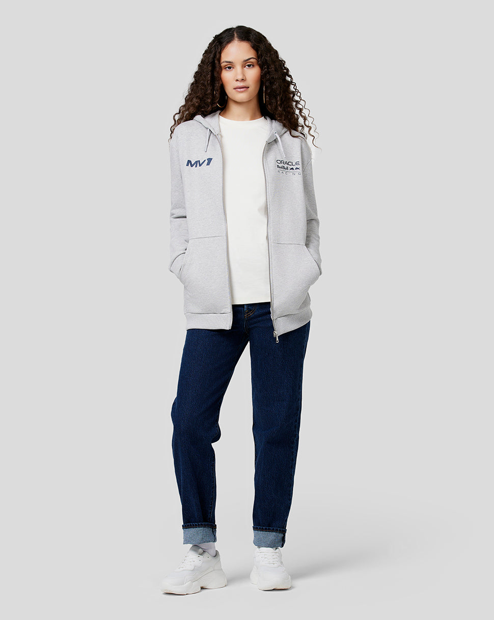 Female model wearing a grey marl Max Helmet Zip Hoodie with MV1 and Oracle Red Bull Racing logos on the chest.