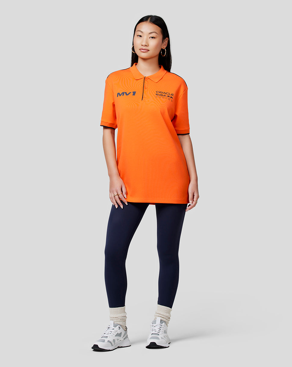 Female model in orange Oracle Red Bull Racing Max polo showing MV1 and RBR logos on the chest