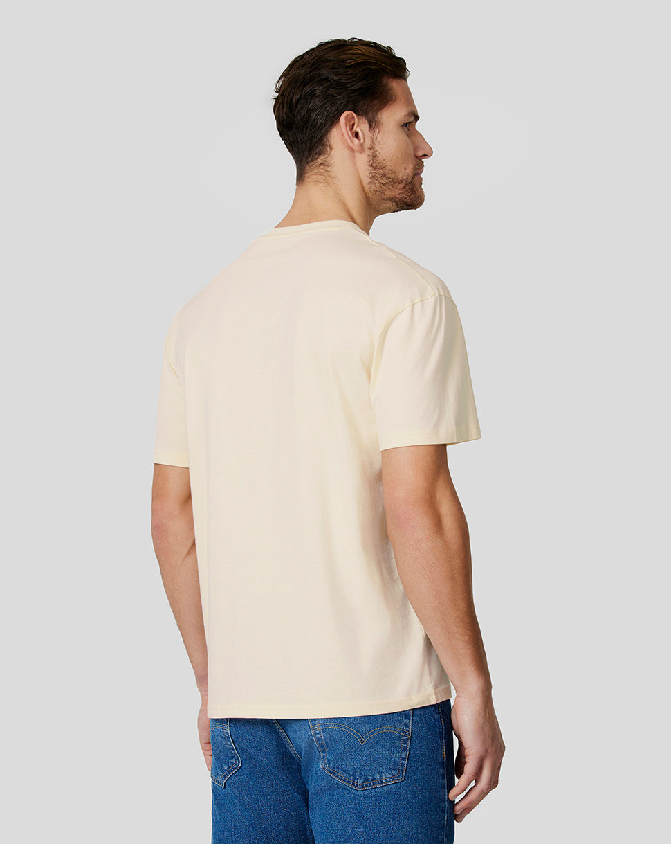 Back view of a man wearing a cream oversized T shirt from the Oracle Red Bull Racing collection.