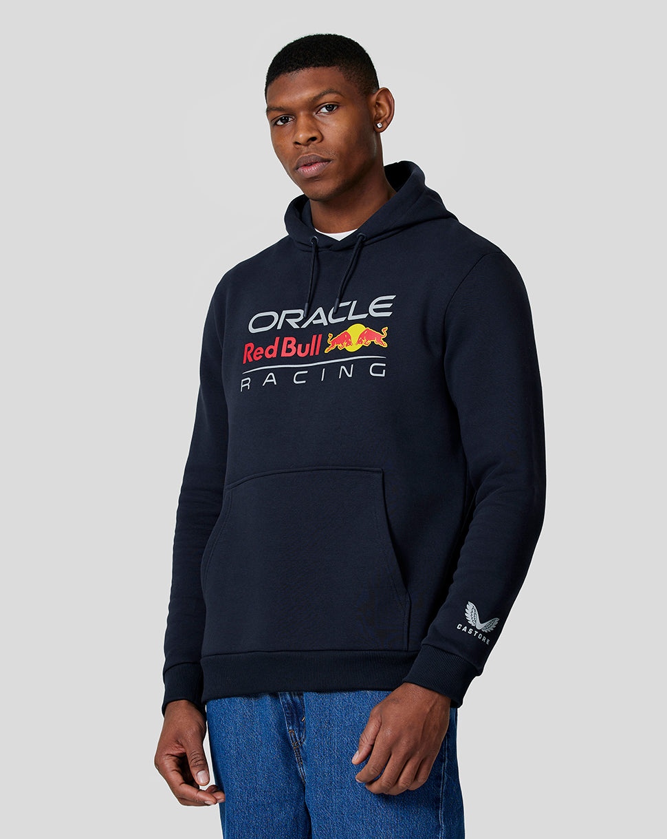 Man wearing navy Oracle Red Bull Racing hoodie with chest logo and adjustable drawstring hood.