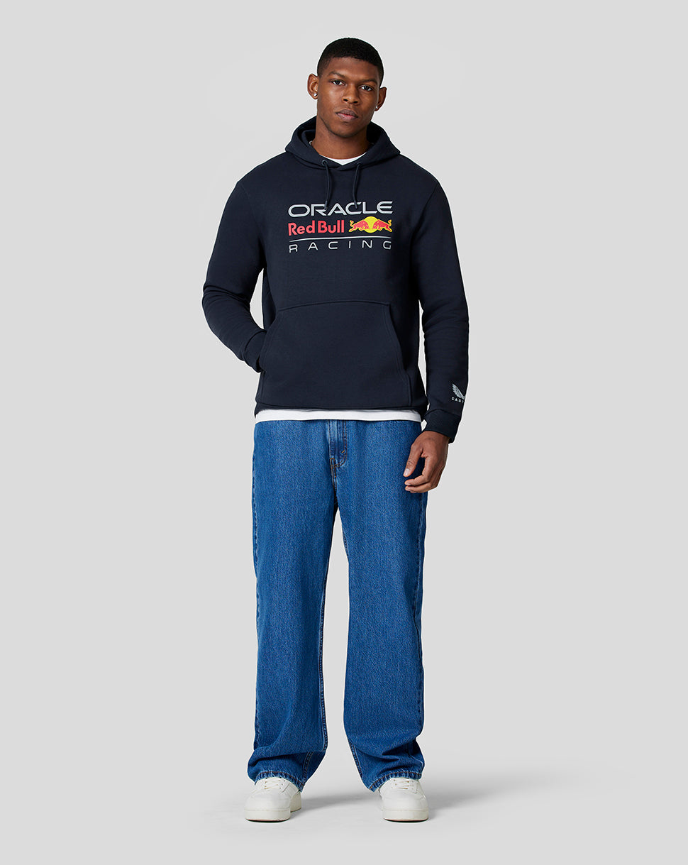 Male model wearing night sky navy Oracle Red Bull Racing hoodie with chest logo and front pocket