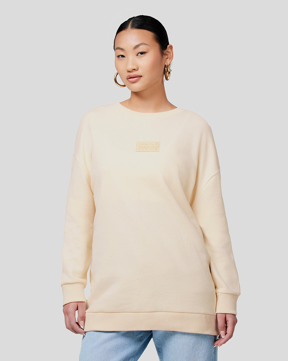 Model wearing Oracle Red Bull Racing unisex tonal oversized crew neck sweatshirt in ecru with a subtle chest logo.