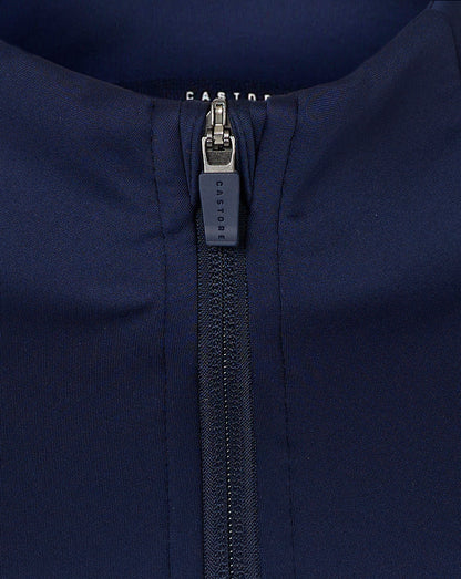 Close up of navy jacket zipper with Castore branding and neckline detail