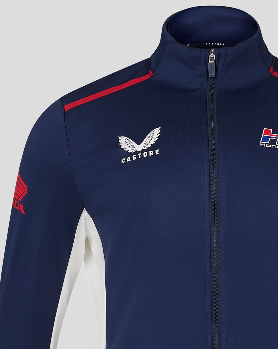 Close up of navy softshell jacket with front zip and Castore branding on the chest alongside Honda Racing badge
