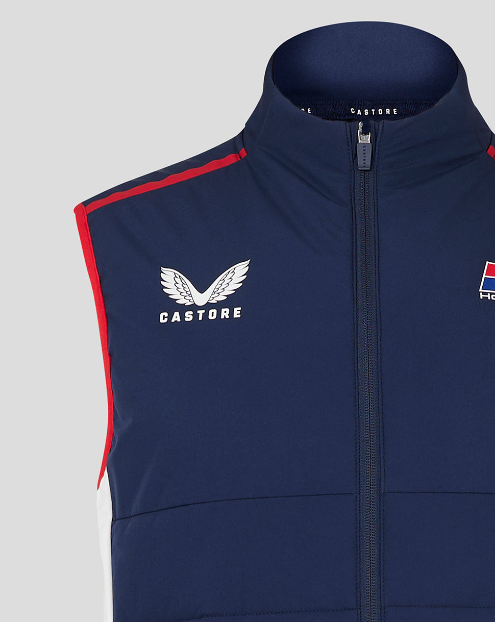 Close-up of navy Honda racing gilet with red shoulder piping, center zip, Castore logo on left chest and Honda branding on right.