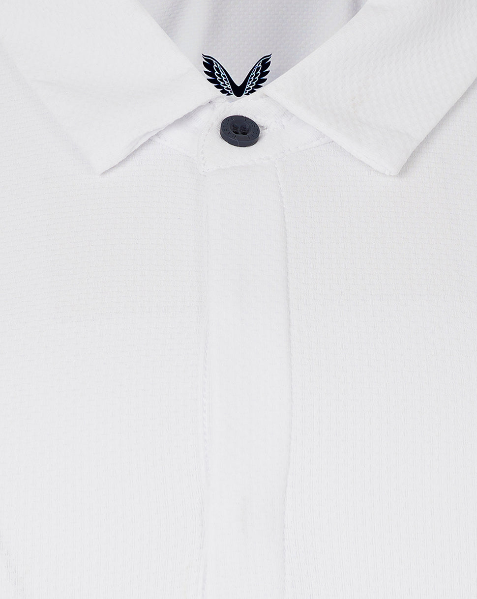 Close-up of white polo collar with concealed placket and Castore emblem at the neckline.