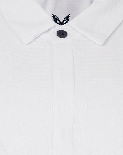 Close-up of white polo collar with concealed placket and Castore emblem at the neckline.