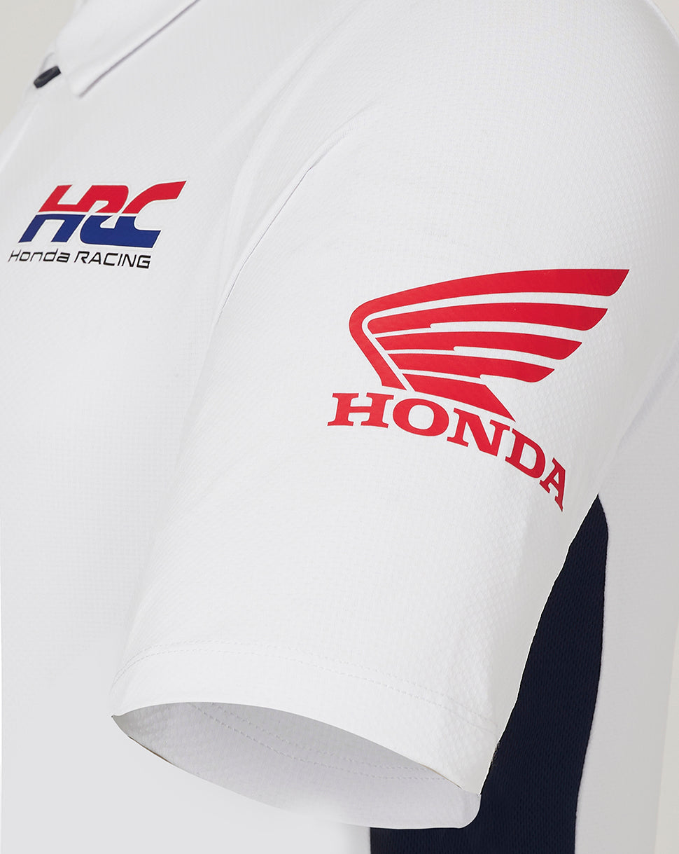 Close-up of white Honda polo sleeve with red wing logo and HRC Honda Racing emblem on the chest.