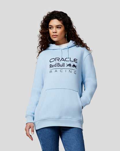 Woman wearing Dream Blue Oracle Red Bull Racing hoodie with a front pocket and chest logo.