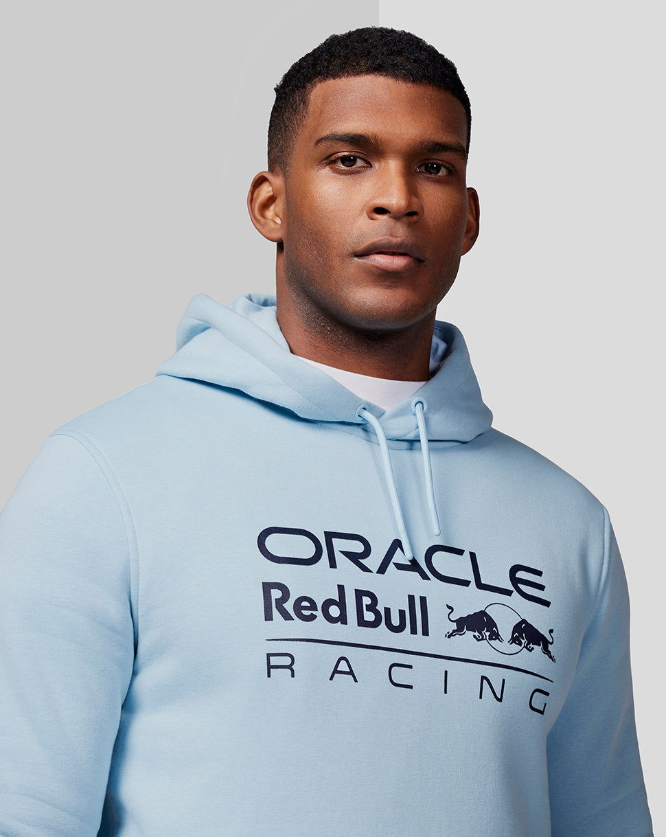 Male model wearing Dream Blue Oracle Red Bull Racing hoodie with front chest logo and drawstring hood.