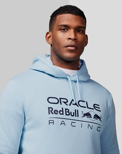 Male model wearing Dream Blue Oracle Red Bull Racing hoodie with front chest logo and drawstring hood.