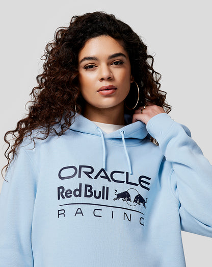 Woman wearing light blue Oracle Red Bull Racing hoodie with chest logo and drawstring hood