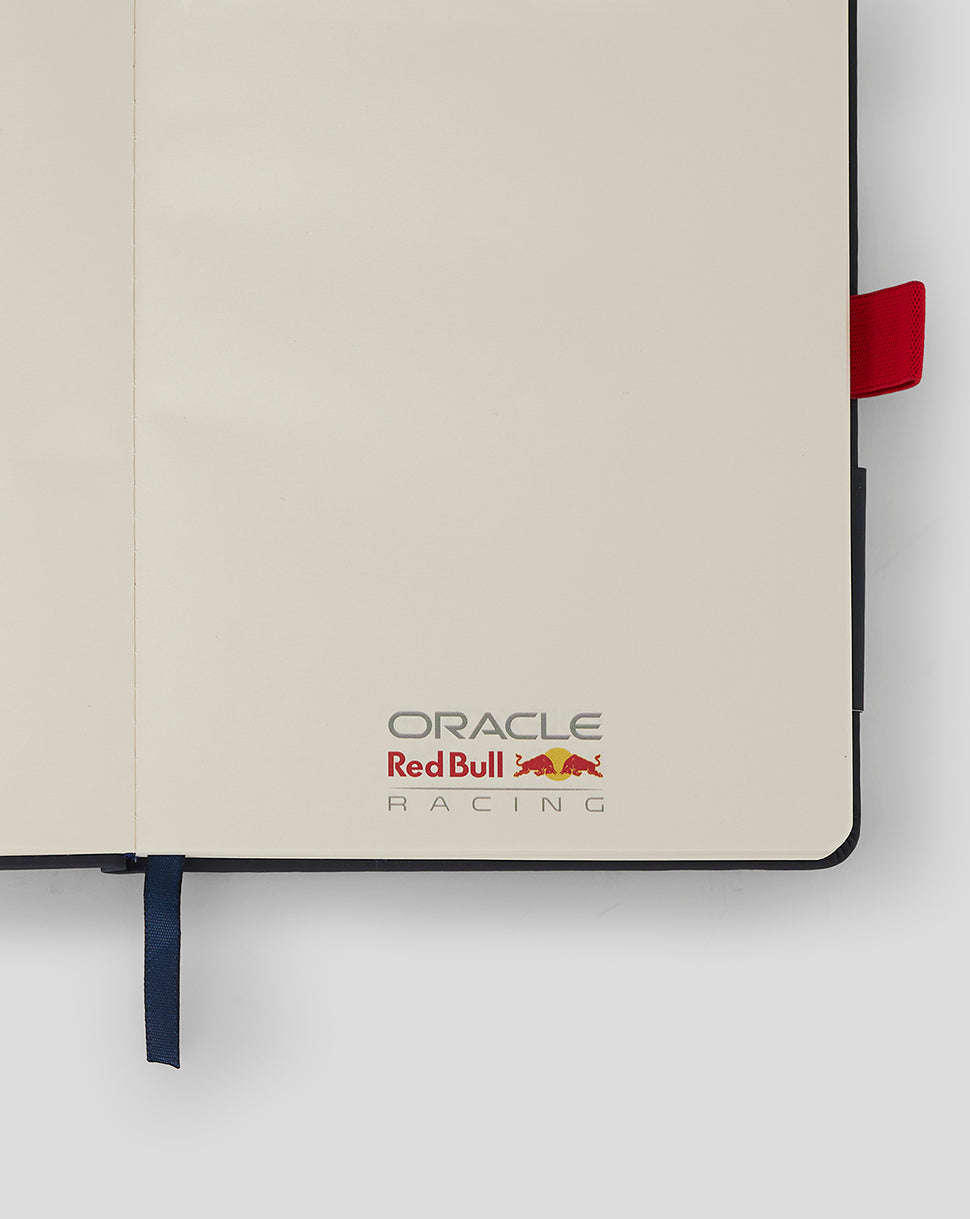 Open page of the Oracle Red Bull Racing notebook showing blank cream sheets with the logo at the bottom corner