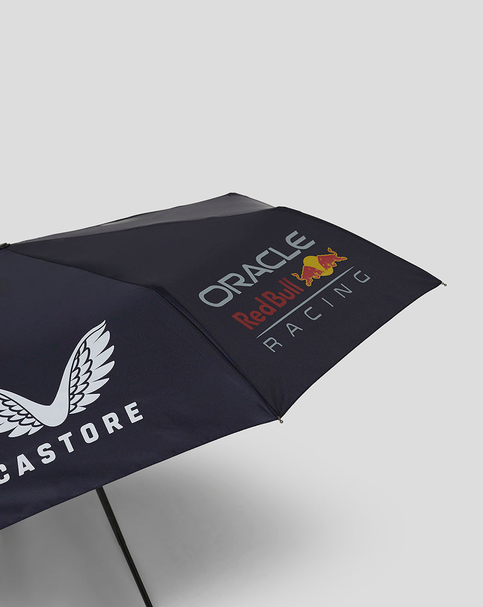 Angled view of navy Red Bull Racing umbrella displaying Oracle branding and Red Bull logos