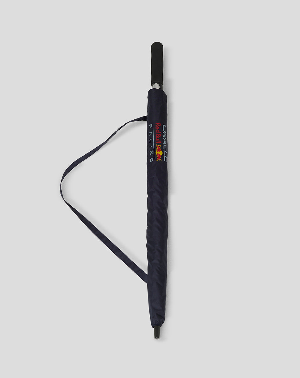 Folded navy Red Bull Racing umbrella with branding on the side strap.