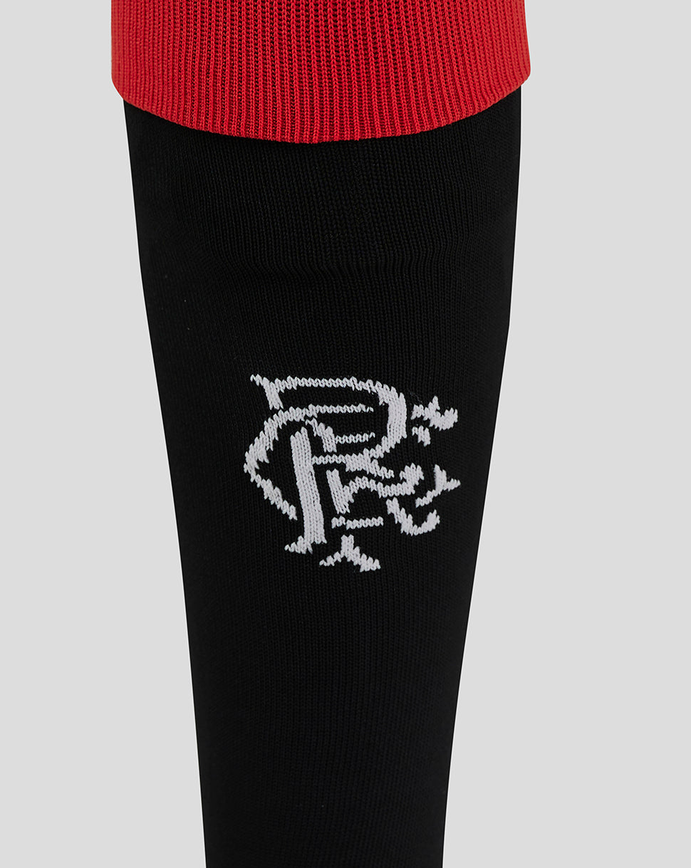 Close-up of black junior Rangers sock with red cuff and a white crest on the shin.