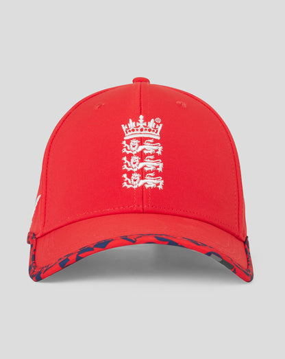 Close up of fiery red England T20 cap showing embroidered front crest and blue patterned brim