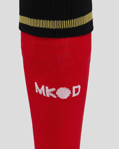 Close up of Mk Dons away sock in red with black cuff and gold stripe and white Mk Dons logo
