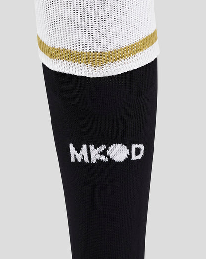 Junior Mk Dons third socks in black with a white logo on the leg and a white cuff with a gold stripe