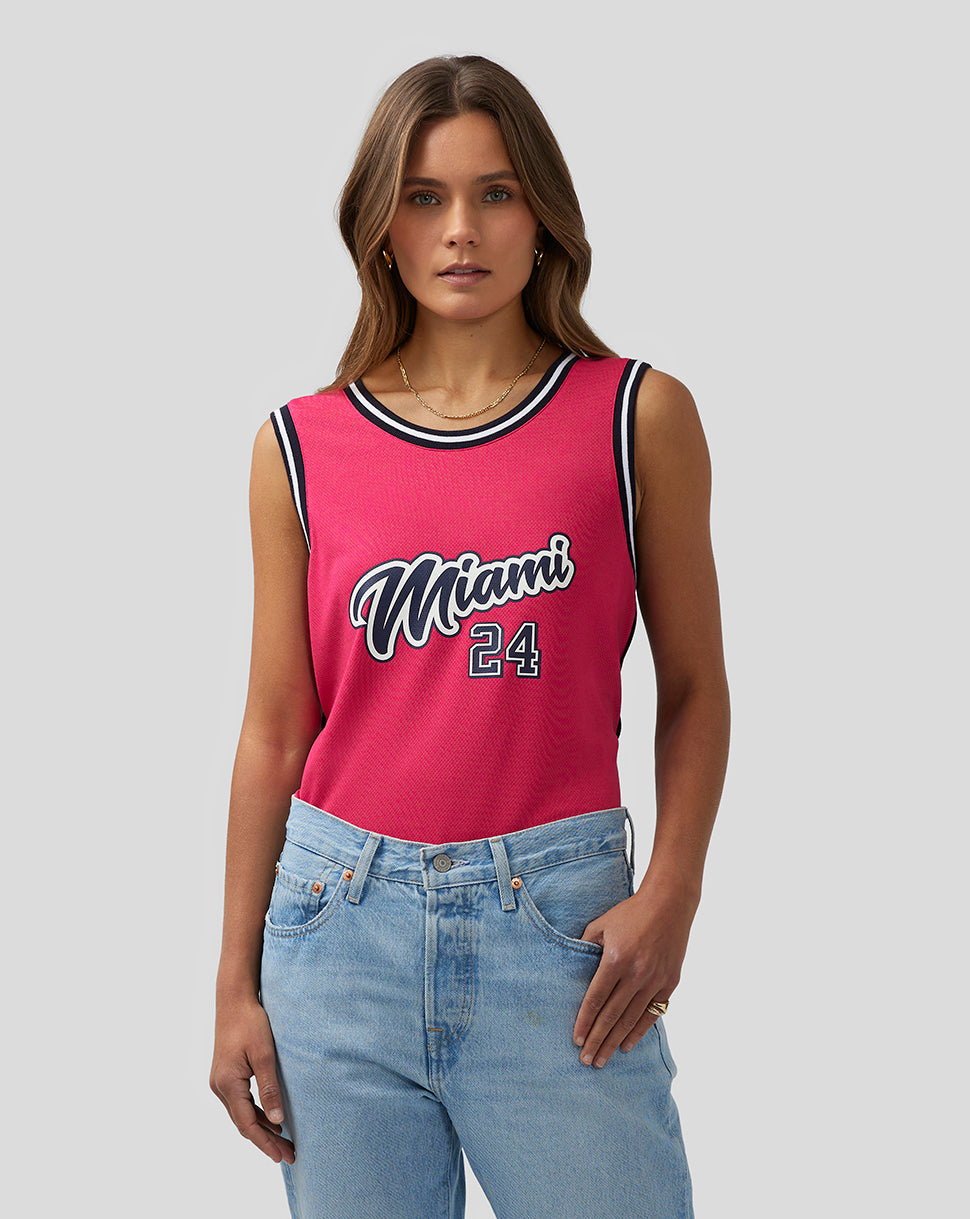 Female model wearing pink Miami basketball jersey with Miami 24 graphic