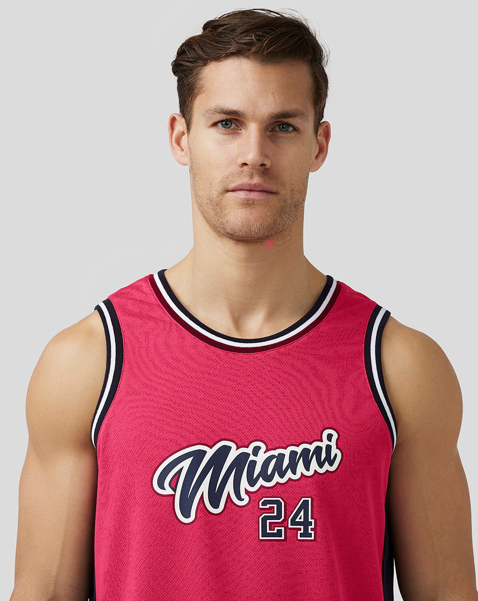 Male model wearing pink Miami basketball jersey front view with Miami 24 graphic.