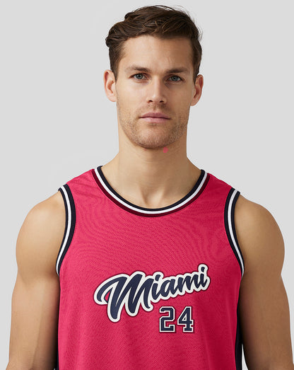 Male model wearing pink Miami basketball jersey front view with Miami 24 graphic.