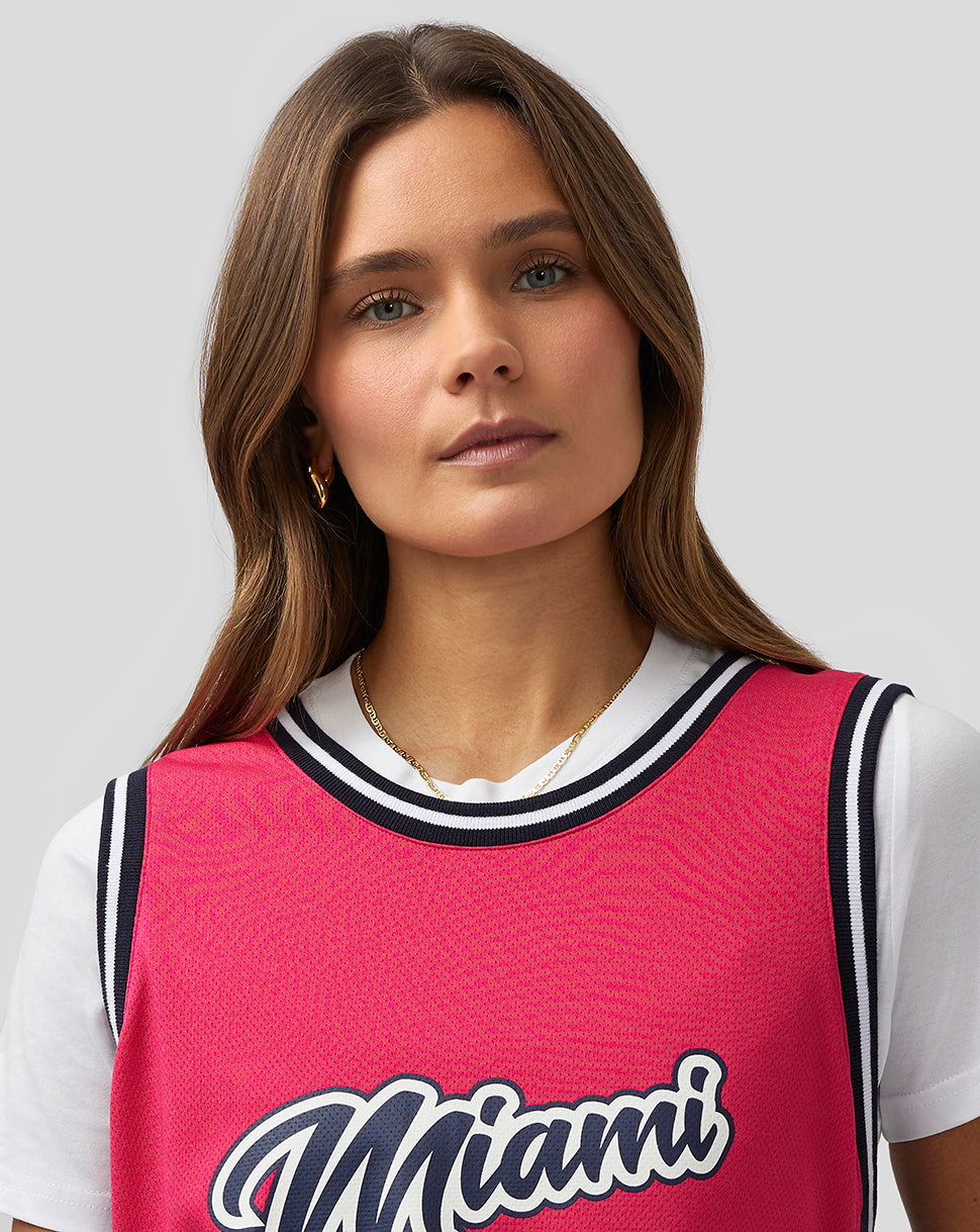 Front view of bright pink Miami basketball jersey with Miami script and number 24