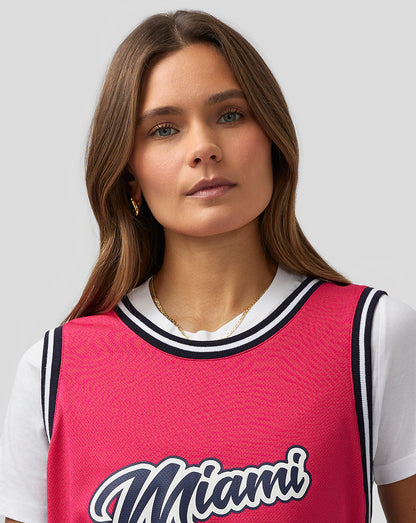 Front view of bright pink Miami basketball jersey with Miami script and number 24
