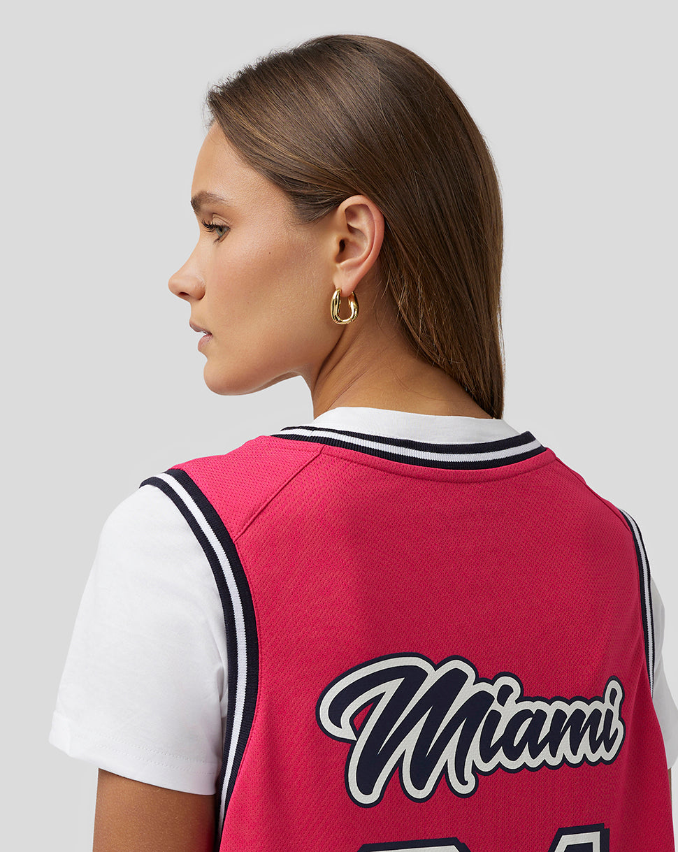 Rear view of a model wearing a pink Miami basketball jersey with Miami script and the number 24