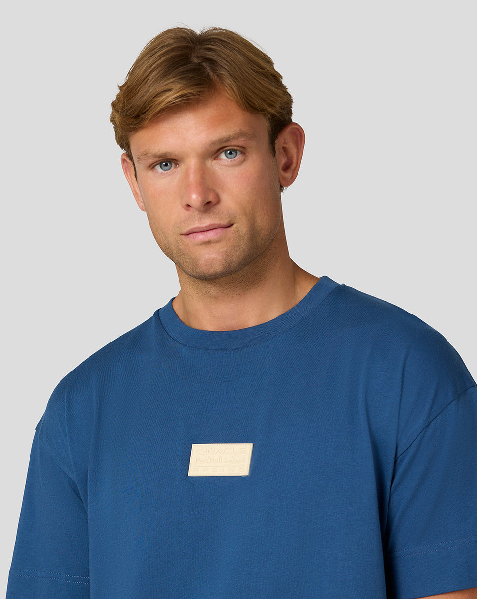 Front view of blue Oracle Red Bull Racing Austin T Shirt with a small gold rectangular badge on the chest