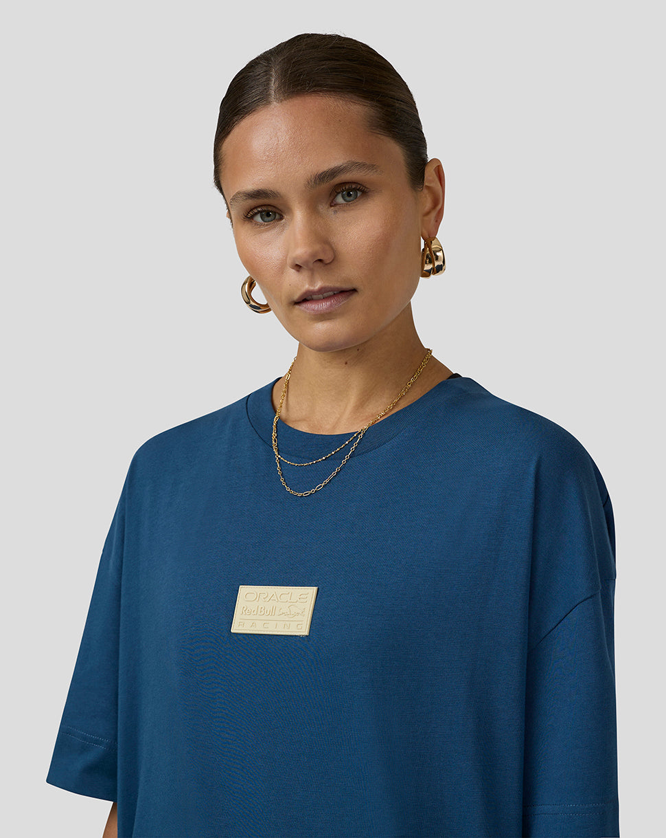 Front view of a blue Oracle Red Bull Racing Austin short sleeve T shirt worn by a model with a gold chest plaque